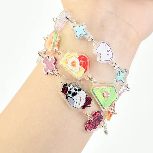 Colorful custom acrylic connection bracelets with playful cartoon charms on a wrist