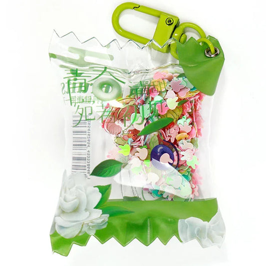 Custom acrylic candy keychain with green clasp, floral accents, and colorful heart confetti inside.