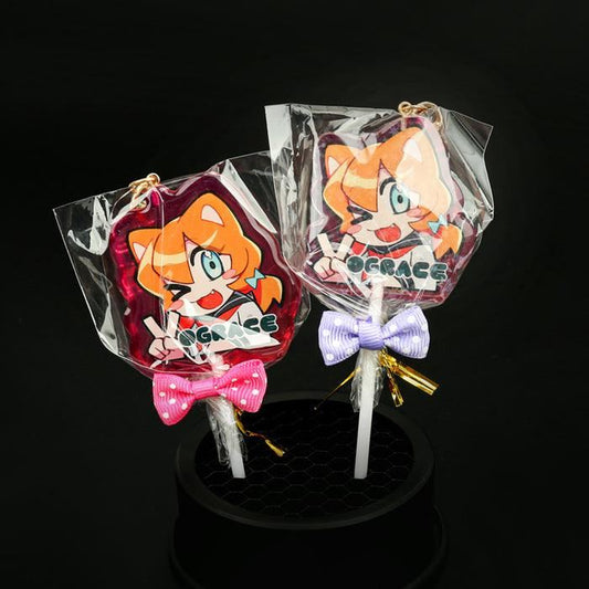 Custom acrylic lollipop charms with anime character art, bows, and transparent packaging