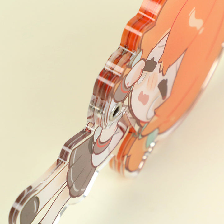 Close-up of a multi-layer acrylic keychain with cute anime-style character design