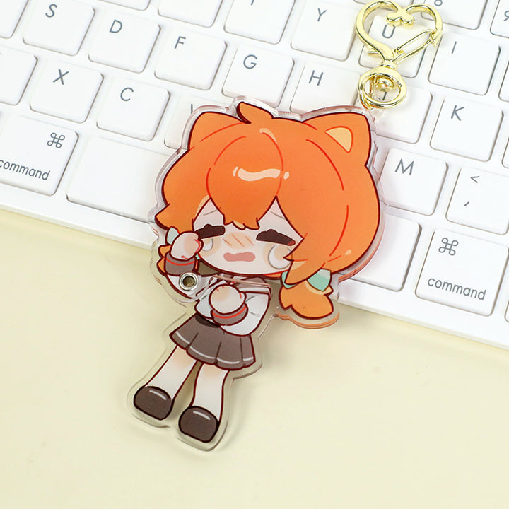 Custom multi-layer acrylic keychain with cute orange-haired anime character on a keyboard