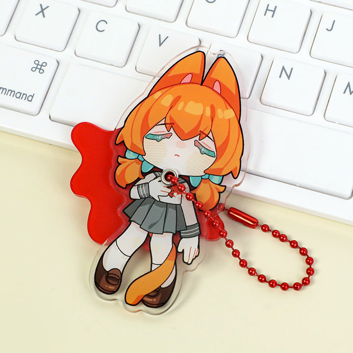 Custom multi-layer acrylic keychain with orange-haired anime girl and red ball chain on keyboard